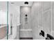 Modern walk-in shower featuring gray tiling, a built-in bench, and rainfall shower head fixture at 3975 Night Star Trl, Odessa, FL 33556
