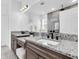 Modern bathroom with dual sinks, granite countertops, and a large mirror at 3975 Night Star Trl, Odessa, FL 33556
