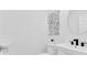 Bathroom with a white sink, toilet, and modern artwork on the wall at 3975 Night Star Trl, Odessa, FL 33556