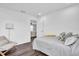 Bedroom featuring a gray upholstered headboard, stylish pillows, and wood floors at 3975 Night Star Trl, Odessa, FL 33556