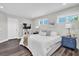 Bright bedroom boasts wood floors, lots of natural light, and coordinating nightstands and decor at 3975 Night Star Trl, Odessa, FL 33556