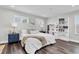 Bright bedroom boasts wood floors, lots of natural light, and coordinating nightstands and decor at 3975 Night Star Trl, Odessa, FL 33556