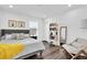 Bedroom with a gray upholstered headboard, decorative pillows, and dark wood floors at 3975 Night Star Trl, Odessa, FL 33556