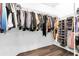 Spacious walk-in closet with wood flooring and ample storage with visible hanging rods and shelves at 3975 Night Star Trl, Odessa, FL 33556