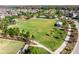 Spacious community green with playground, pool, and walking paths surrounded by neighborhood homes at 3975 Night Star Trl, Odessa, FL 33556