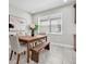 A dining room with natural light, a wooden table, neutral decor and tile floors at 3975 Night Star Trl, Odessa, FL 33556