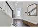 Bright entryway featuring wood floors, staircase, and contemporary design elements at 3975 Night Star Trl, Odessa, FL 33556