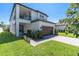 Beautiful home featuring a covered porch, two-car garage and manicured landscaping at 3975 Night Star Trl, Odessa, FL 33556