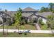 Aerial view of well maintained two-story home with manicured lawn and mature trees at 3975 Night Star Trl, Odessa, FL 33556