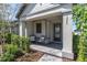 Inviting covered front porch with stylish seating and a paved walkway to the front door at 3975 Night Star Trl, Odessa, FL 33556
