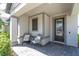 Welcoming front porch with chairs, stylish accents, and brick flooring at 3975 Night Star Trl, Odessa, FL 33556