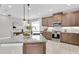 Bright kitchen with a granite island, modern appliances, and dining area with modern decor at 3975 Night Star Trl, Odessa, FL 33556