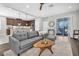 Spacious living area with a comfortable gray sofa and natural light at 3975 Night Star Trl, Odessa, FL 33556