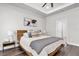 Bright main bedroom with hardwood floors, tray ceiling, and modern decor at 3975 Night Star Trl, Odessa, FL 33556