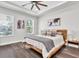 Bright main bedroom with hardwood floors, tray ceiling, and two large windows at 3975 Night Star Trl, Odessa, FL 33556