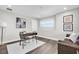 Office space with a brown couch, modern desk, chair, and wall decor at 3975 Night Star Trl, Odessa, FL 33556