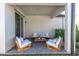 Covered patio featuring an outdoor seating area with comfortable furniture and manicured landscaping at 3975 Night Star Trl, Odessa, FL 33556
