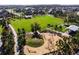 Aerial view of the community playground area with wood chip ground cover, climbing features, and seating at 3975 Night Star Trl, Odessa, FL 33556