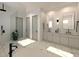 Sleek bathroom featuring modern fixtures, dual vanities, a walk-in shower, and elegant marble flooring at 4112 Southern Valley Loop, Brooksville, FL 34601