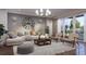 Inviting living room featuring a large sofa, decorative rug, and floor-to-ceiling windows offering natural light at 4112 Southern Valley Loop, Brooksville, FL 34601