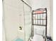 Bathroom with tiled walk-in shower, toilet, decorative shelf, and modern fixtures at 4429 Whitton Way, New Port Richey, FL 34653