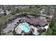 Aerial view of a community pool area with lounge chairs and well-maintained landscaping at 4429 Whitton Way, New Port Richey, FL 34653