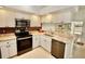 Kitchen with stainless steel appliances, granite countertops, and white cabinets at 4429 Whitton Way, New Port Richey, FL 34653