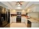 Kitchen with stainless steel appliances, granite countertops and white cabinets at 4429 Whitton Way, New Port Richey, FL 34653