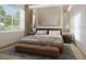 Inviting bedroom with a plush rug, a warm color palette, a bench, and a large window at 4611 Hickory Oak Dr, Brooksville, FL 34601