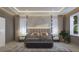 Comfortable main bedroom with ambient lighting, neutral decor, and large windows with sheer curtains at 4611 Hickory Oak Dr, Brooksville, FL 34601