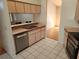 Functional kitchen with stainless steel dishwasher and sink, and light pink colored cabinetry at 5227 Kirkwood Ave, Spring Hill, FL 34608