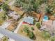 Aerial view of the home showing the backyard, pool, mature trees and surrounding neighborhood at 5249 Courtland Rd, Spring Hill, FL 34608