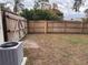 Backyard with a wooden fence and an AC unit at 5249 Courtland Rd, Spring Hill, FL 34608