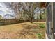 Spacious backyard featuring a large tree and a wood fence for privacy at 5249 Courtland Rd, Spring Hill, FL 34608