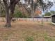 Backyard with wooden fence, mature tree, and spanish moss at 5249 Courtland Rd, Spring Hill, FL 34608