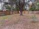 Fenced backyard featuring mature trees and spanish moss at 5249 Courtland Rd, Spring Hill, FL 34608
