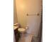 A partial view of a bathroom showing a toilet, towel rack, and patterned shower curtain at 5249 Courtland Rd, Spring Hill, FL 34608