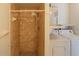 Tiled shower with showerhead, plus a washing machine and water heater at 5249 Courtland Rd, Spring Hill, FL 34608