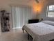 This bedroom features neutral tile flooring, a ceiling fan, and a large window at 5249 Courtland Rd, Spring Hill, FL 34608