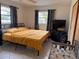 This bedroom features neutral tile flooring and large windows providing plenty of natural light at 5249 Courtland Rd, Spring Hill, FL 34608