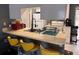 Well-lit kitchen featuring bar seating, modern fixtures, and convenient layout at 5249 Courtland Rd, Spring Hill, FL 34608