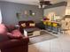Cozy living area with a kitchen view, features neutral tones, and tile flooring at 5249 Courtland Rd, Spring Hill, FL 34608