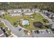 Aerial view showcases a community pool, pond, and manicured green spaces, offering a resort-style living experience at 5360 Riverwalk Preserve Dr, New Port Richey, FL 34653