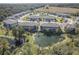 Aerial view showcases a well-planned community with lush landscaping and a tranquil pond, enhancing the serene environment at 5360 Riverwalk Preserve Dr, New Port Richey, FL 34653