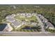 Community aerial view showcases a pool, pond, and lush green spaces, offering a vibrant and tranquil living environment at 5360 Riverwalk Preserve Dr, New Port Richey, FL 34653