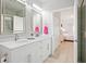 Elegant bathroom featuring dual sinks, marble countertops, and easy access to an adjacent bedroom at 5360 Riverwalk Preserve Dr, New Port Richey, FL 34653