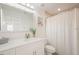 Clean bathroom with marble countertop, white cabinets, and shower-tub combination at 5360 Riverwalk Preserve Dr, New Port Richey, FL 34653