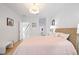 Bright bedroom with a wicker bed frame, side tables, and ample natural light, located near the staircase at 5360 Riverwalk Preserve Dr, New Port Richey, FL 34653
