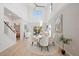 Elegant dining area with a high ceiling, decorative rug, and access to outdoor patio at 5360 Riverwalk Preserve Dr, New Port Richey, FL 34653
