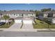 New townhomes feature a paver driveway, two car garage, and manicured front lawn at 5360 Riverwalk Preserve Dr, New Port Richey, FL 34653